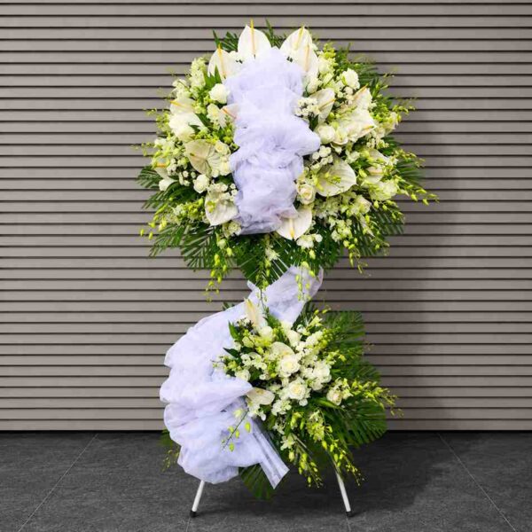 Kệ chia buồn tiễn biệt 606 với thiết kế hai tầng hoa trắng sang trọng, kết hợp hoa ly, hoa hồng và lá xanh tạo vẻ trang nghiêm, tinh tế.