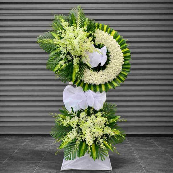 Kệ hoa chia buồn 322 thiết kế vòng hoa trắng kết hợp lá xanh sang trọng, kiểu dáng hiện đại thể hiện sự tiếc thương và kính trọng sâu sắc