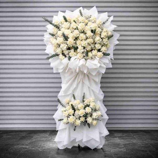 Kệ hoa chia buồn 360 tông trắng sang trọng với hoa hồng trắng, hoa phụ trắng kết hợp lá eucalyptus xanh tạo vẻ trang nhã và tinh tế.