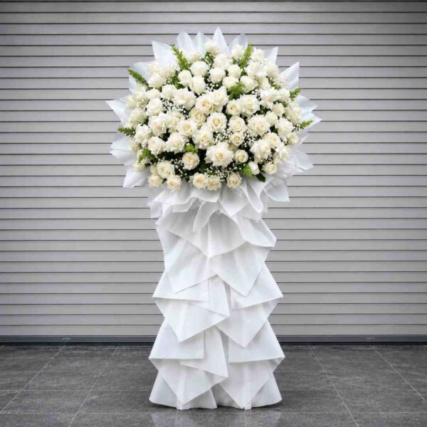 Hoa Viếng Tang Lễ Lời Tiễn Biệt 517 với tông trắng trang nhã từ hoa hồng trắng kết hợp hoa baby và lá xanh, thiết kế kệ hoa cao sang trọng thể hiện sự tiếc thương chân thành.